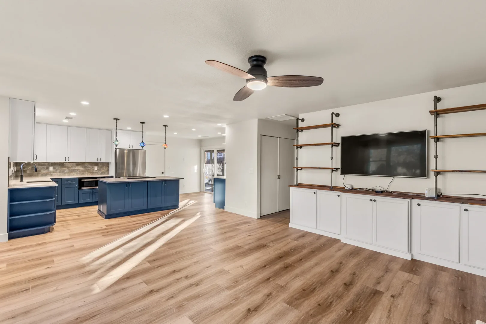 Home addition and kitchen remodel in Cheshire Flagstaff AZ with open concept layout, navy island, and built-in shelving by Barden Home Builders