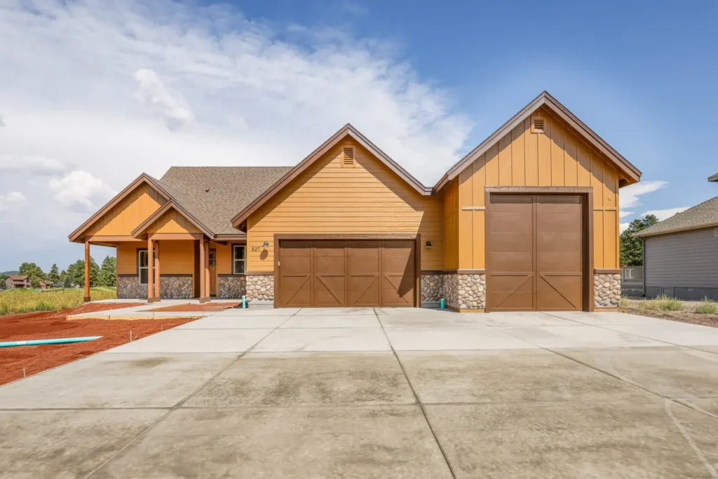 Custom home exterior with attached 3-car garage, Flagstaff AZ, built by Barden Home Builders